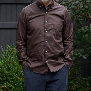 Model wearing single needle shirt in dark brown standing